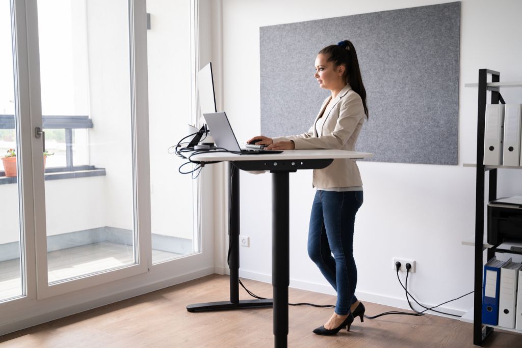 Woman working in the office on a standing desk